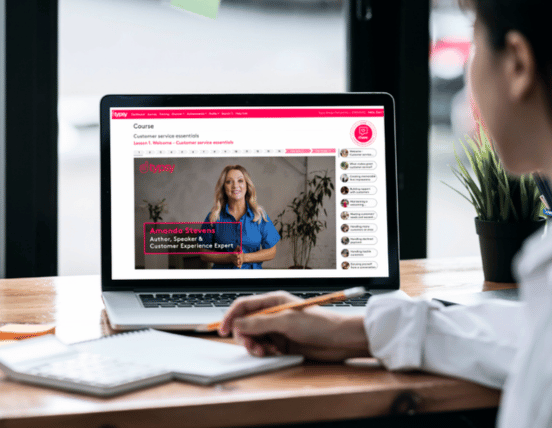 Hospitality professional completing online customer service training on laptop